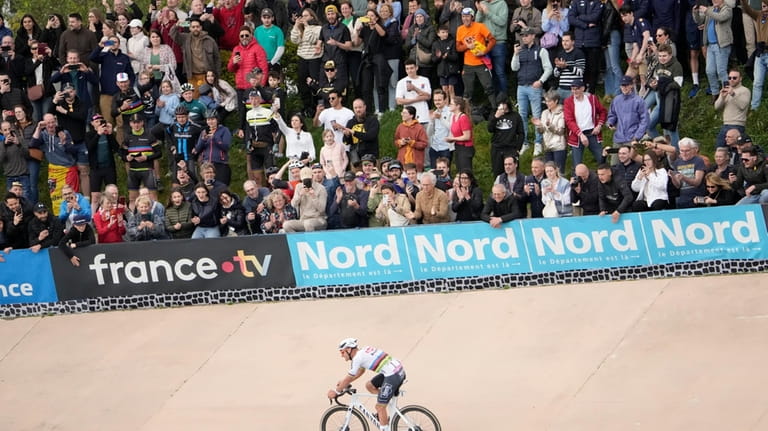 Netherland's Mathieu van der Poel rides to win the men's...