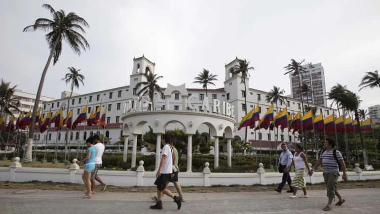 People walk past Hotel El Caribe in Cartagena, Colombia. (April...