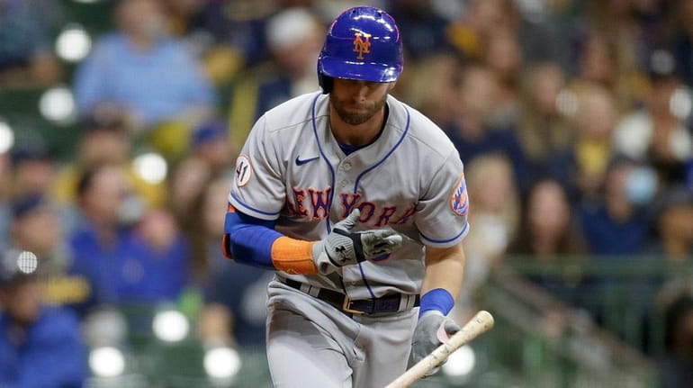 Jeff McNeil of the Mets throws his bat after flying...