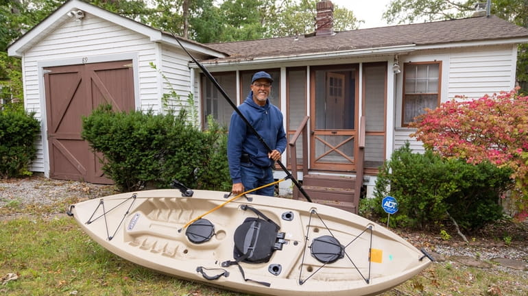 Tyrone Sellers, an avid kayaker and fisherman, at the cabin he and...