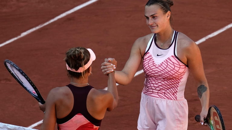 Aryna Sabalenka of Belarus, right, shakes hands with her opponent...