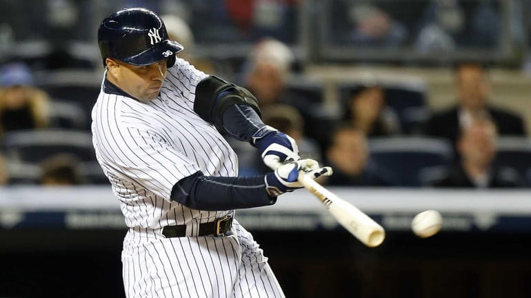 Carlos Beltran of the Yankees connects on a third-inning base...
