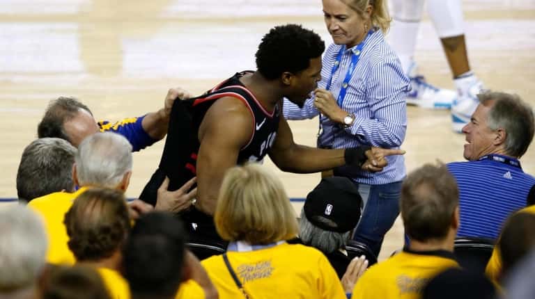 Kyle Lowry of the Toronto Raptors yells at a fan...