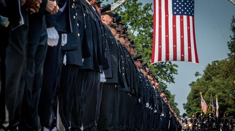Police, family and loved ones at the August funeral for...