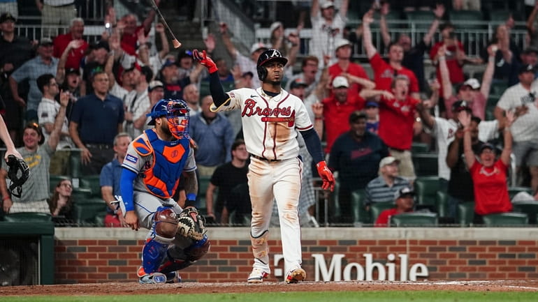 Atlanta second baseman Ozzie Albies (1) reacts after hitting a...