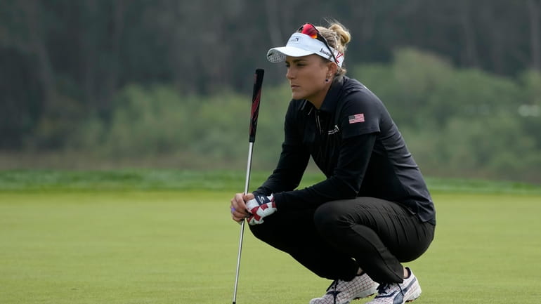 Lexi Thompson, of the United States, waits to putt on...