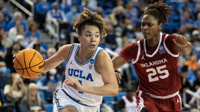 UCLA guard Kiki Rice, left, drives towards the basket as...