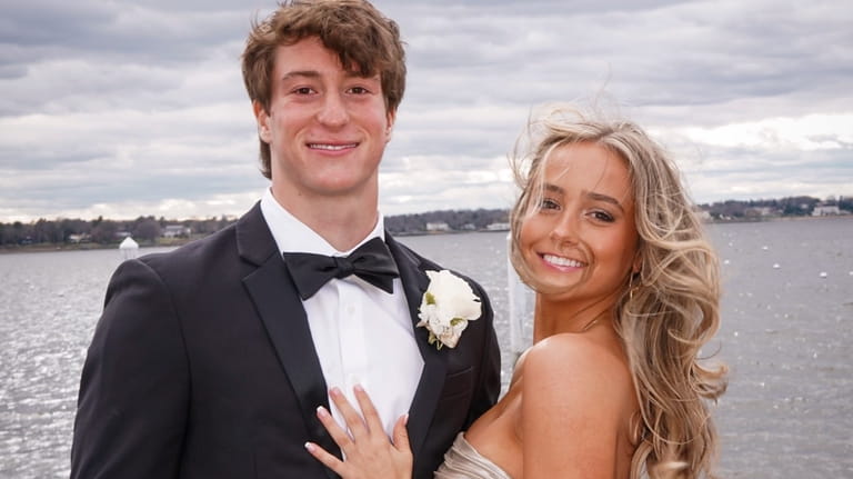Carys Hyland and her date, Ben Fox, both 18, strike...