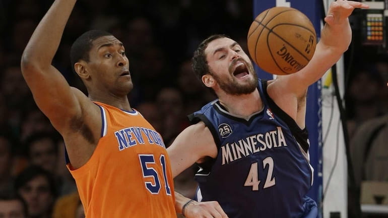Minnesota's Kevin Love fights for control of the ball with...