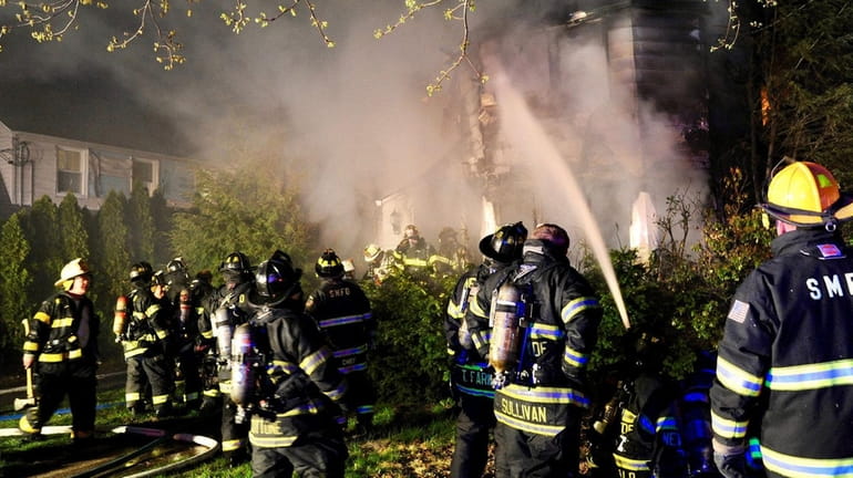 Firefighters work at a house fire on Argyle Road in...