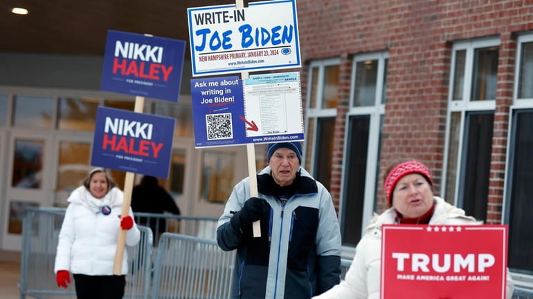Candidate supporters stand outside a polling location in the presidential...