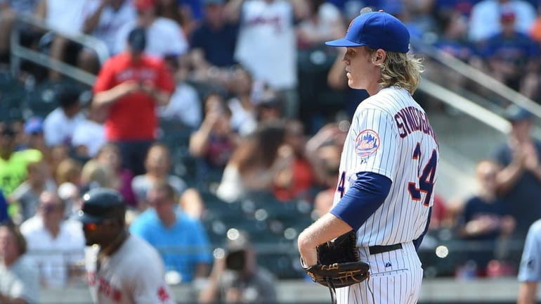 New York Mets starting pitcher Noah Syndergaard stands on the...