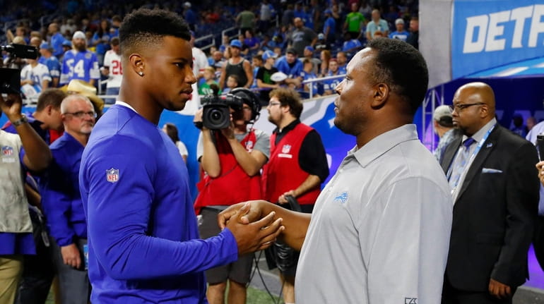 Giants running back Saquon Barkley, left, meets with former Lions...