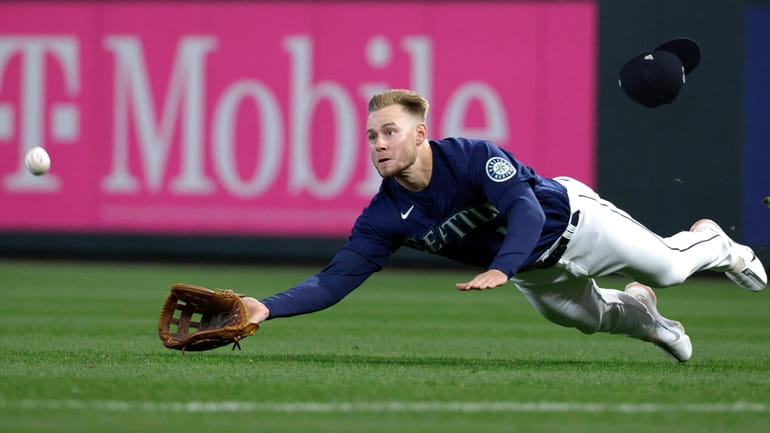 Seattle Mariners right fielder Jarred Kelenic dives for the ball...