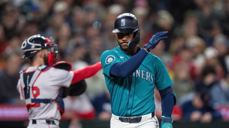 Seattle Mariners' Julio Rodriguez reacts after striking out during the...