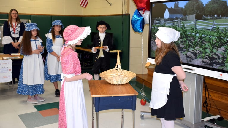 In Ronkonkoma, fourth-graders at Cherokee Elementary School wore old-fashioned clothing and...