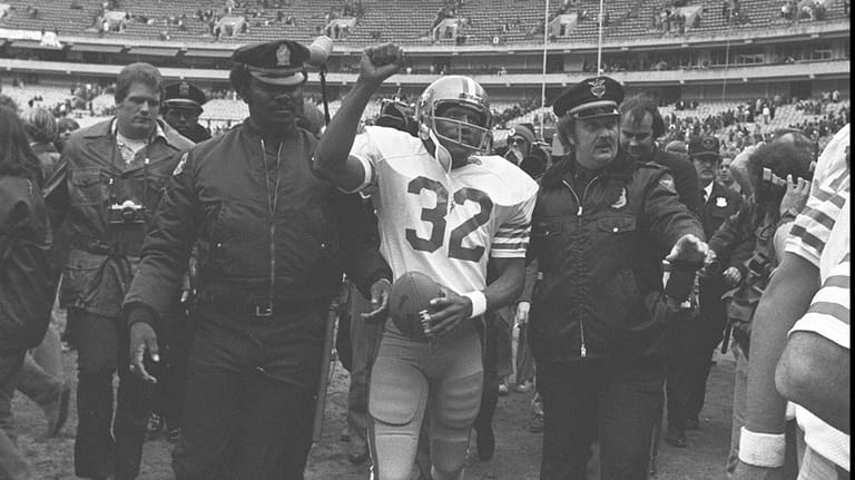 San Francisco 49ers running back O.J. Simpson is escorted from...