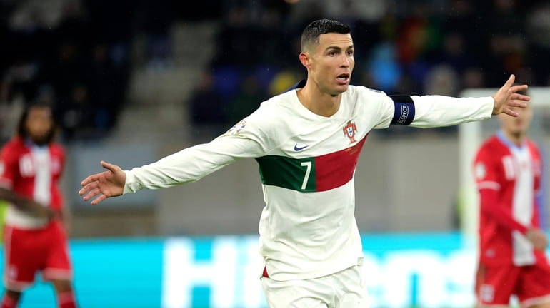Portugal's Cristiano Ronaldo, center, in action during the Euro 2024...