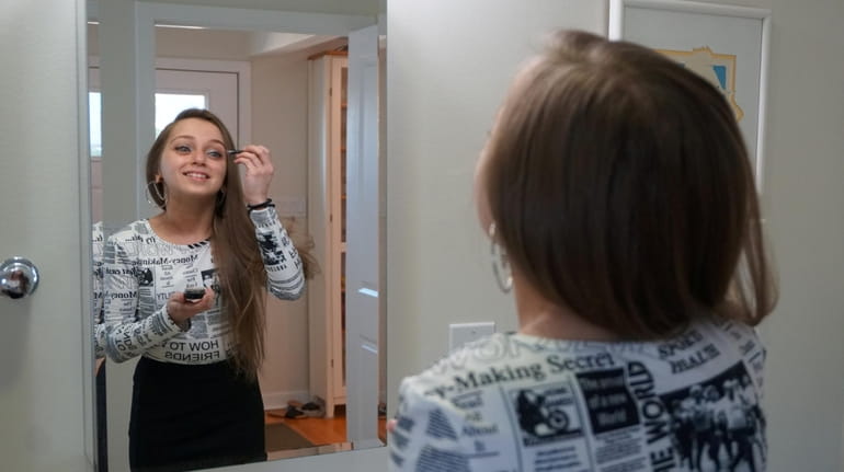 Shauna Rae Lesick puts on her makeup before going out...