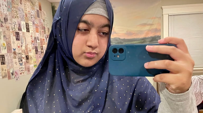 Duaa Qureshi, 16, of East Meadow, shares a selfie wearing...