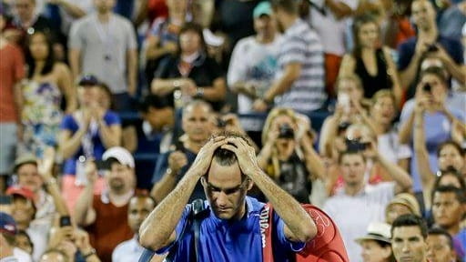 Roger Federer, of Switzerland, walks off the court after losing...