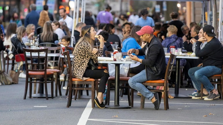 People dine on Main Street in Port Washington in October 2020. Long...