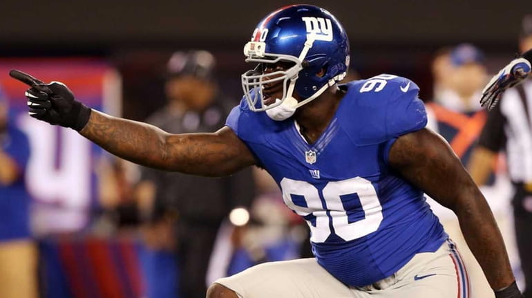 Jason Pierre-Paul celebrates after making a tackle in a game...