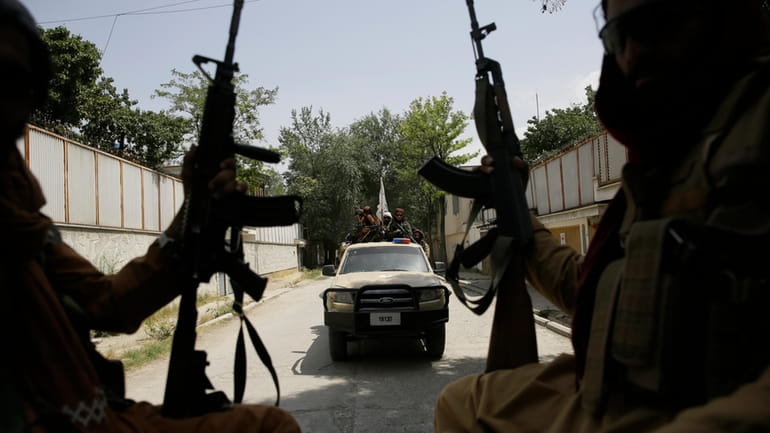 Taliban fighters patrol in Kabul, Afghanistan, on Aug. 19, 2021....
