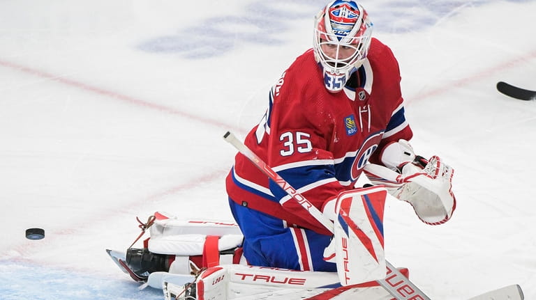 Montreal Canadiens goaltender Sam Montembeault looks back after giving up...