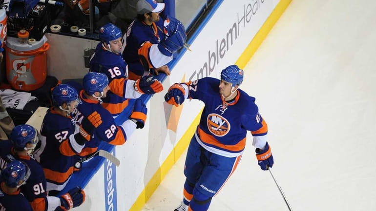 New York Islanders #27 Milan Jurcina is congratulated by teammates...