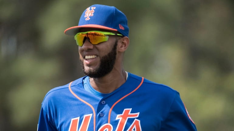 New York Mets prospect Amed Rosario warms up during a...