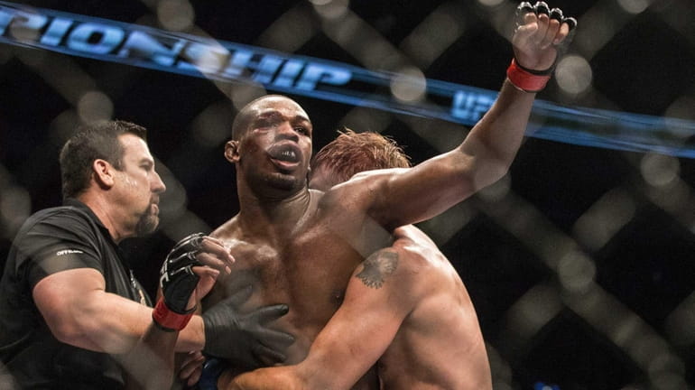 Jon Jones reacts as the referee calls the end to...