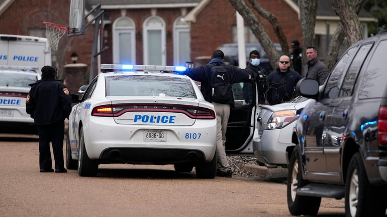 Members of the Memphis Police Department work a crime scene...