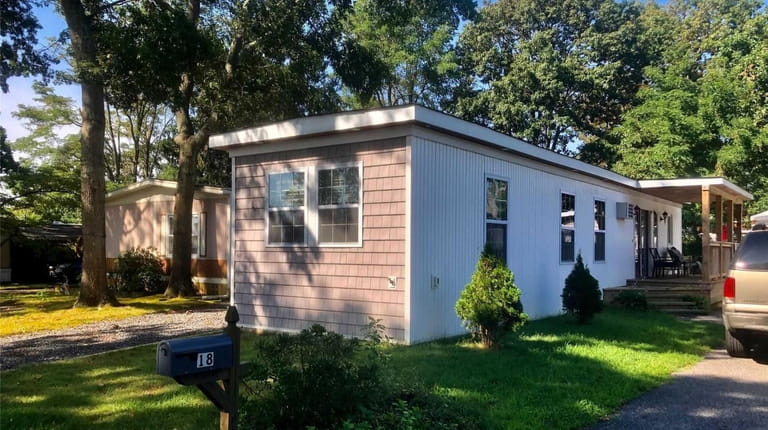 Priced at $125,000 and located on Periwinkle Drive in Bohemia, this two-bedroom,...