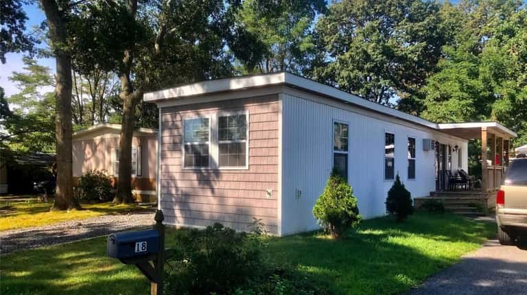 Priced at $125,000 and located on Periwinkle Drive in Bohemia, this two-bedroom,...