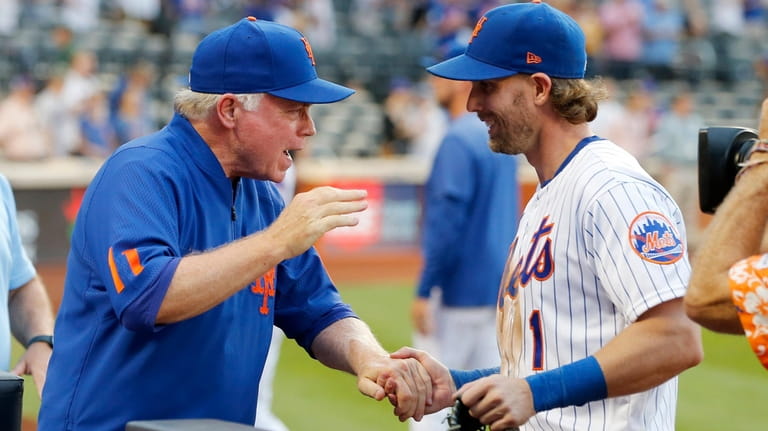 Mets manager Buck Showalter and infielder Jeff McNeil celebrate after defeating Atlanta...