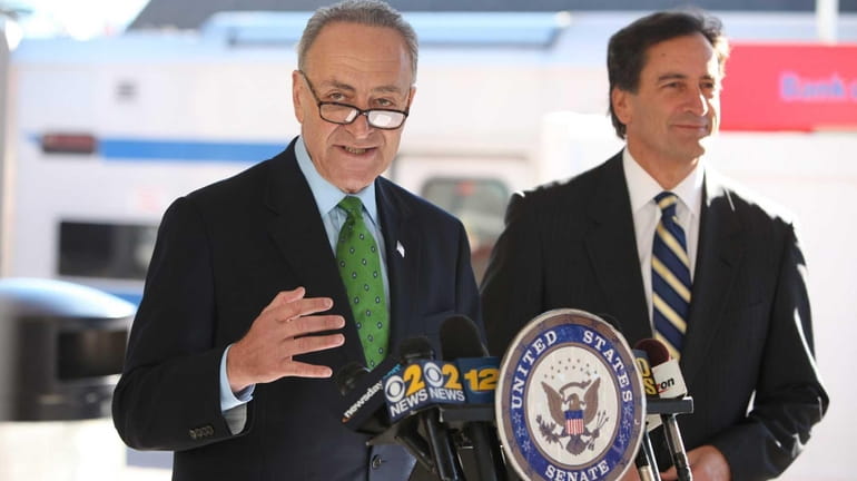 Senator Chuck Schumer, left, speaks about improvements to the problem-plagued...
