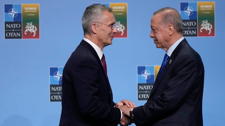 NATO Secretary General Jens Stoltenberg, left, greets Turkish President Recep...