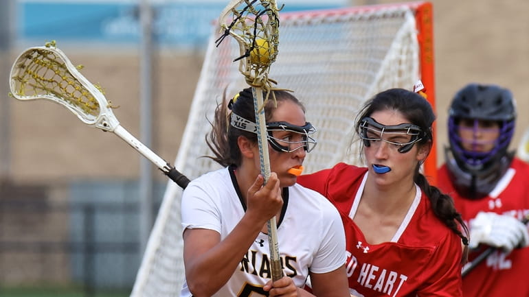 St. Anthony's midfield Tess Calabria looks to get past Sacred...