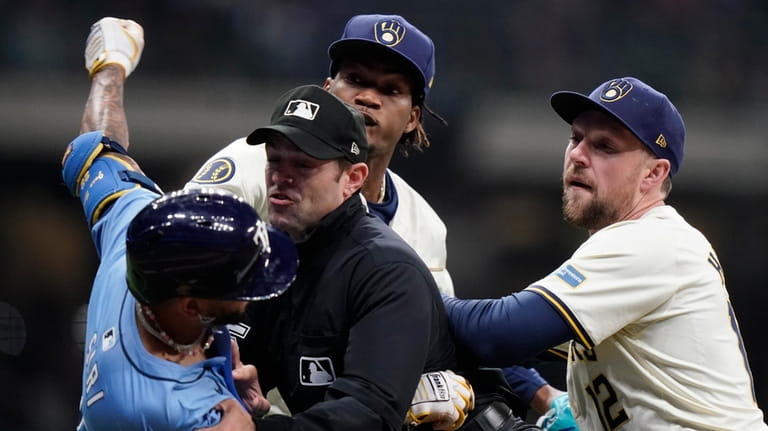 Tampa Bay Rays' Jose Siri, left, fights with Milwaukee Brewers'...